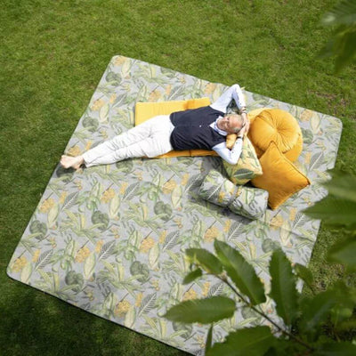 man lying down on outdoor rug