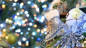Christmas tree decoration blue ski boot on tree with blurred lights in the background