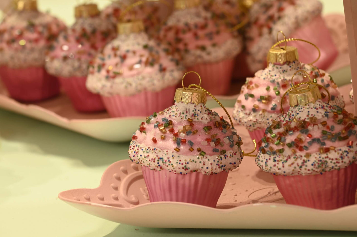Pink cupcake Christmas tree decorations on plate