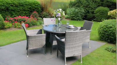 rattan 4 seater dining set on patio in back garden