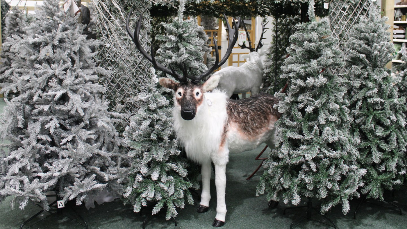 Reindeer in Alpine Ski Lodge Display with Snow Tipped Artificial Christmas Trees