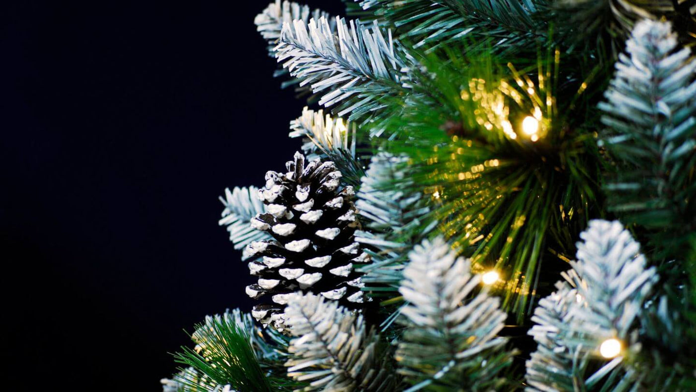 Artificial Christmas Tree Detail with pine cone, fairy lights and snowy tips