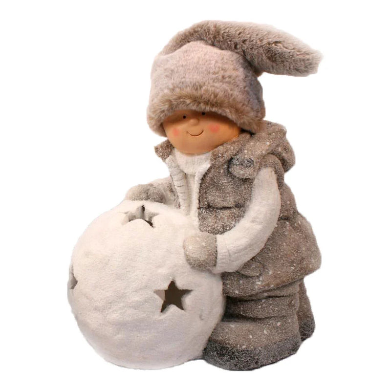 Little Boy in fur hat and brown coat pushing big Snowball with star cutouts LED light