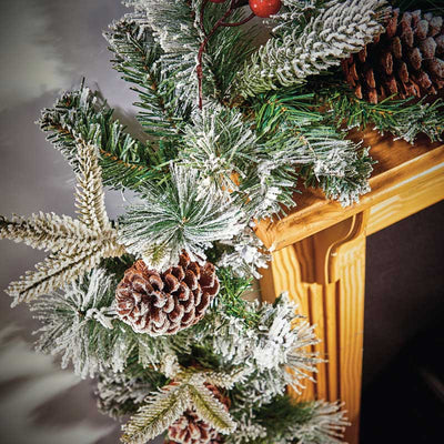 Snowy Garland with Pine Cones and berries on a mantle