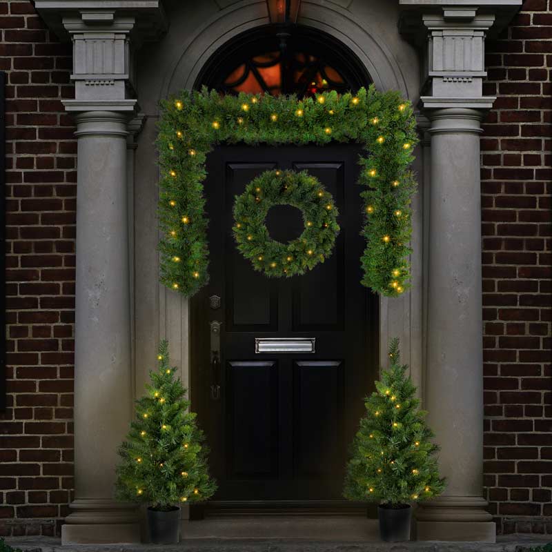 Christmas Outdoor Decoration, two mini Christmas Trees, Pre-lit Garland on door, and prelit Christmas Wreath