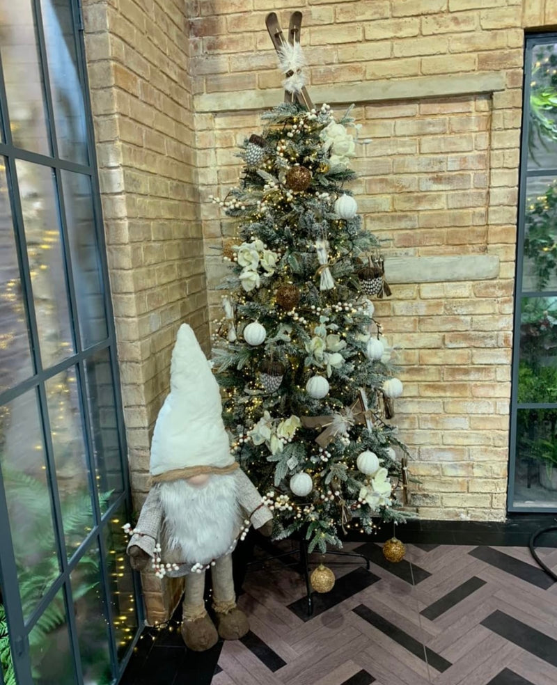 Cream and Brown Christmas Gonk beside decorated Christmas Tree on the Set of Ireland AM
